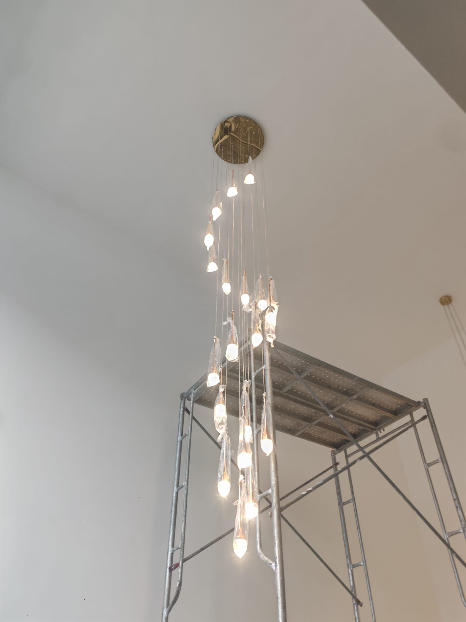 September 2026 DWHOME installation featuring Alabaster Lunar and Raindrop Chandeliers