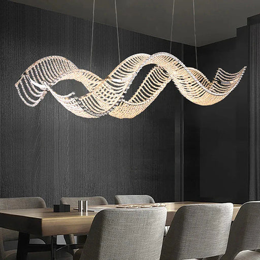 Modern Wave Crystal Chandelier Over Dining Table.