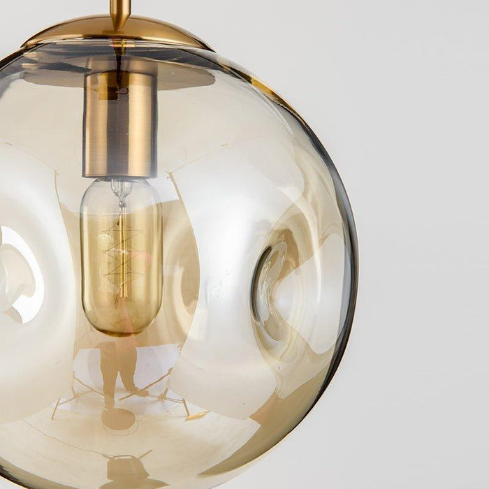 Aminta Dimpled Glass Shade Brass Pendant Light.